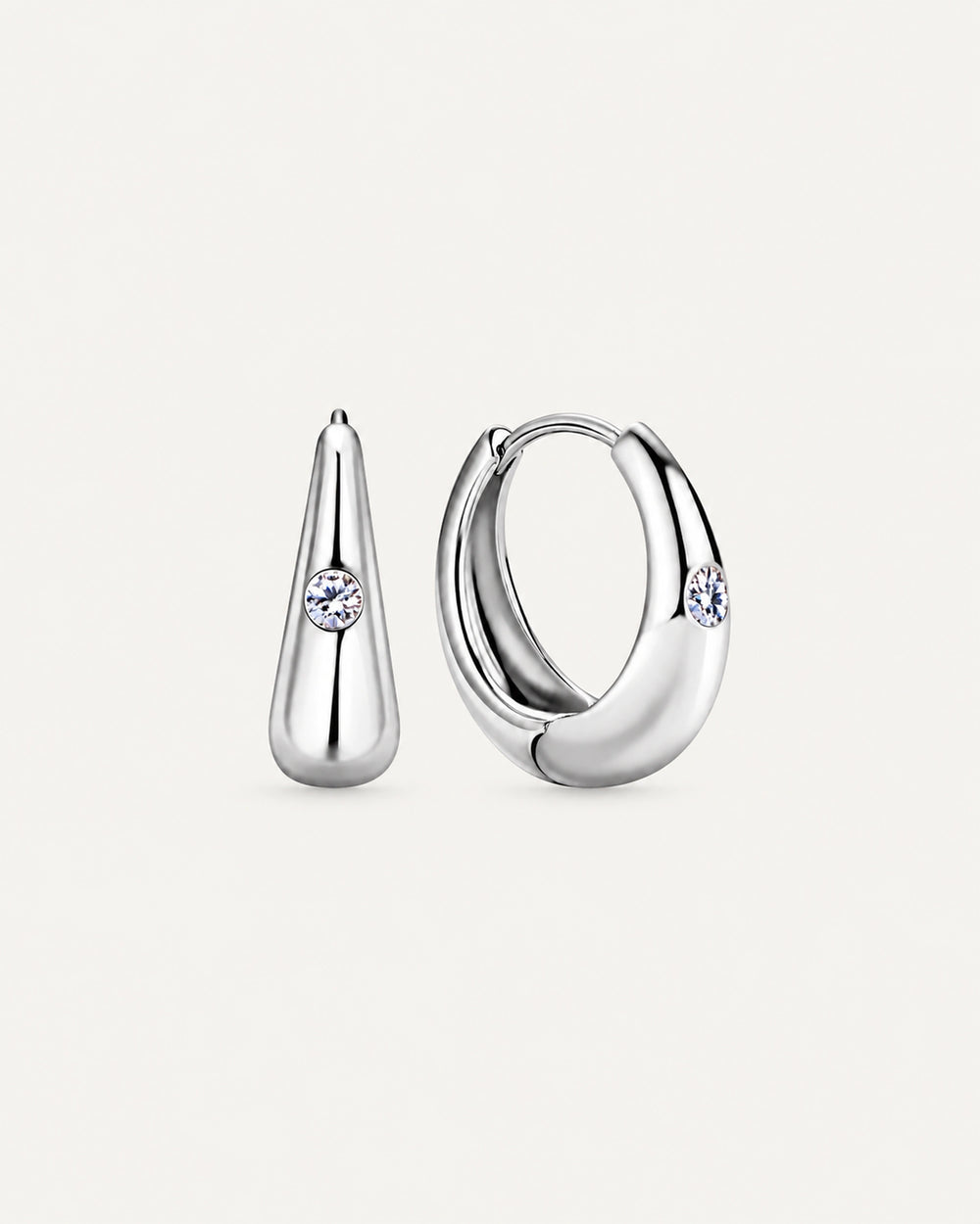Pair of silver Audrey teardrop huggie earrings with one round moissanite accent on each front