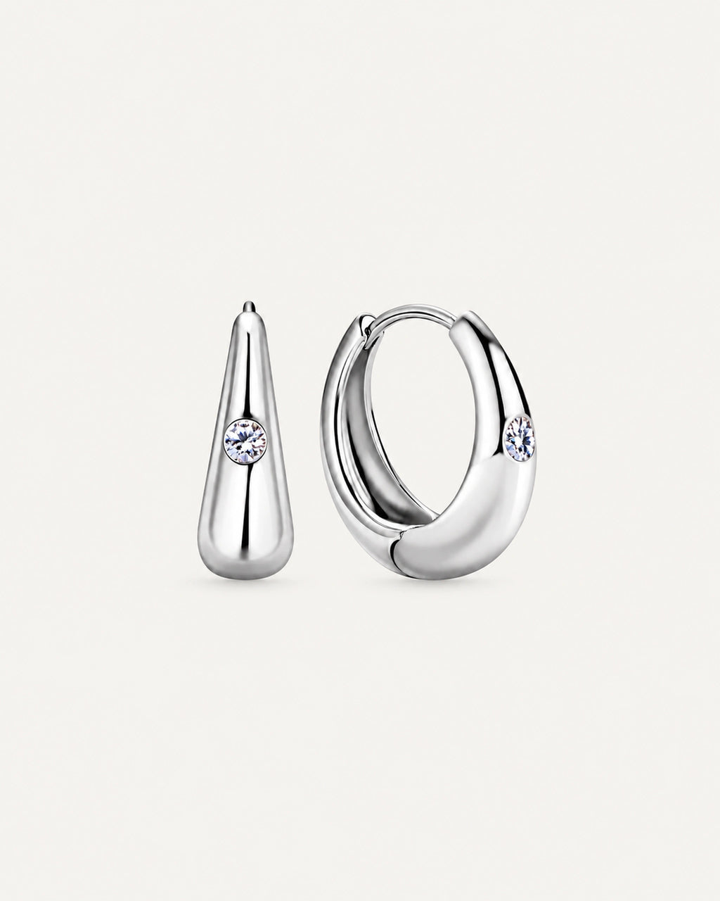 Pair of silver Audrey teardrop huggie earrings with one round moissanite accent on each front