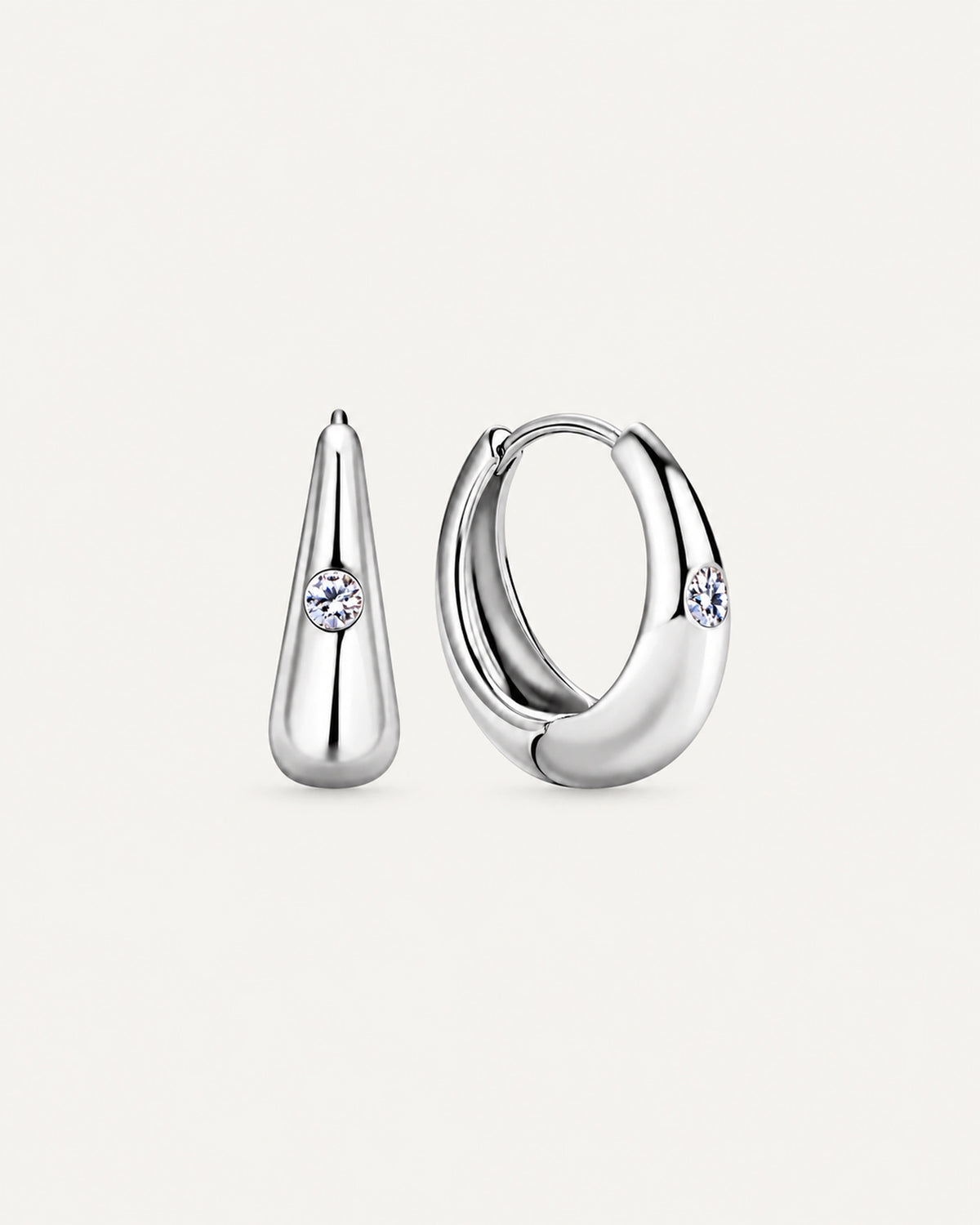 Pair of silver Audrey teardrop huggie earrings with one round moissanite accent on each front