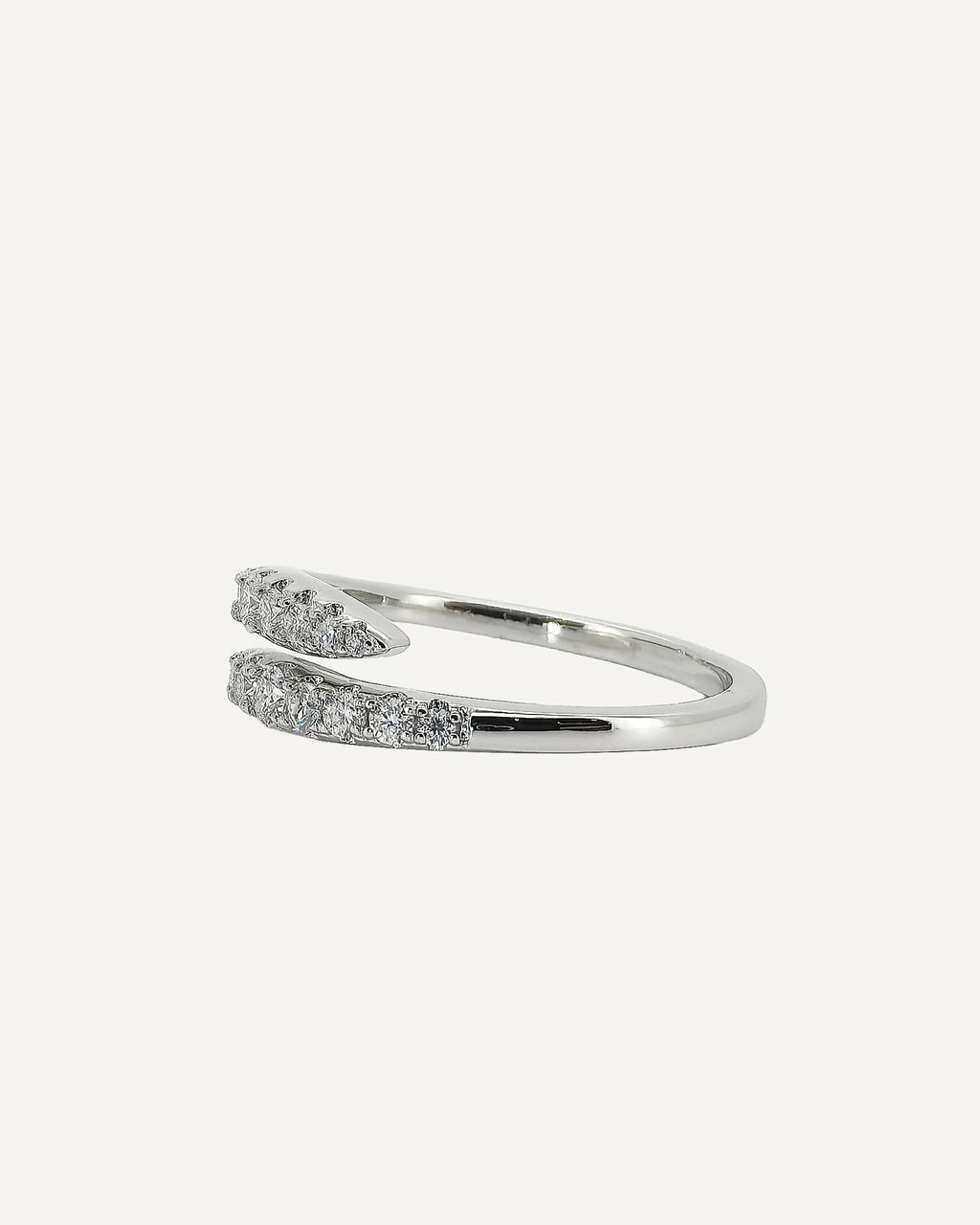 Side view of the Clara silver open-wrap ring, showing its smooth band and two tapered, stone-set ends.