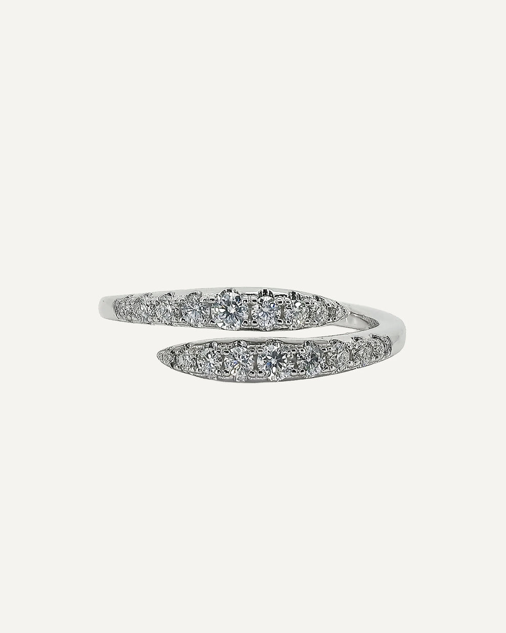 Front view of the Clara open-wrap ring, showing two opposing rows of round moissanite stones in graduated sizes.