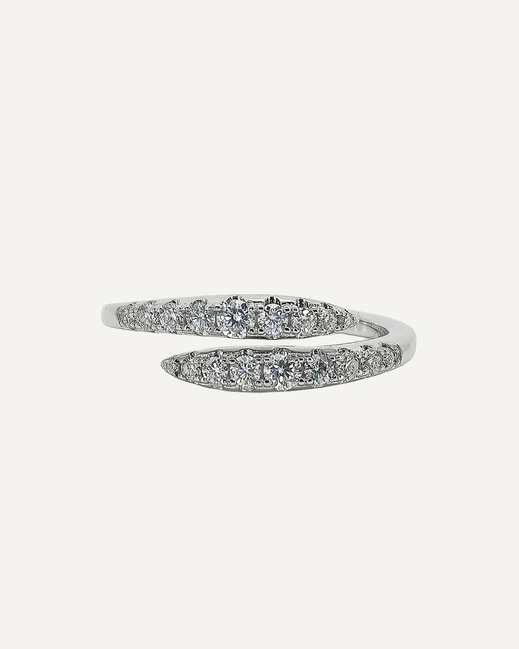 Front view of the Clara open-wrap ring, showing two opposing rows of round moissanite stones in graduated sizes.