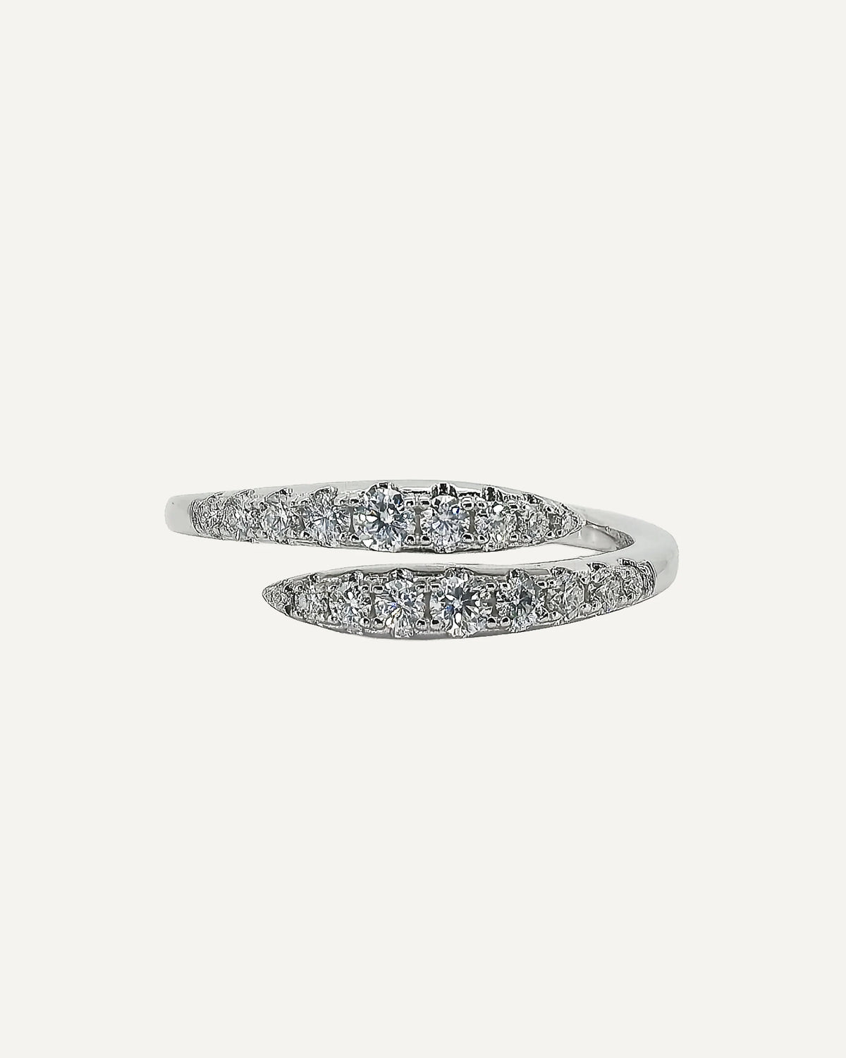 Front view of the Clara open-wrap ring, showing two opposing rows of round moissanite stones in graduated sizes.