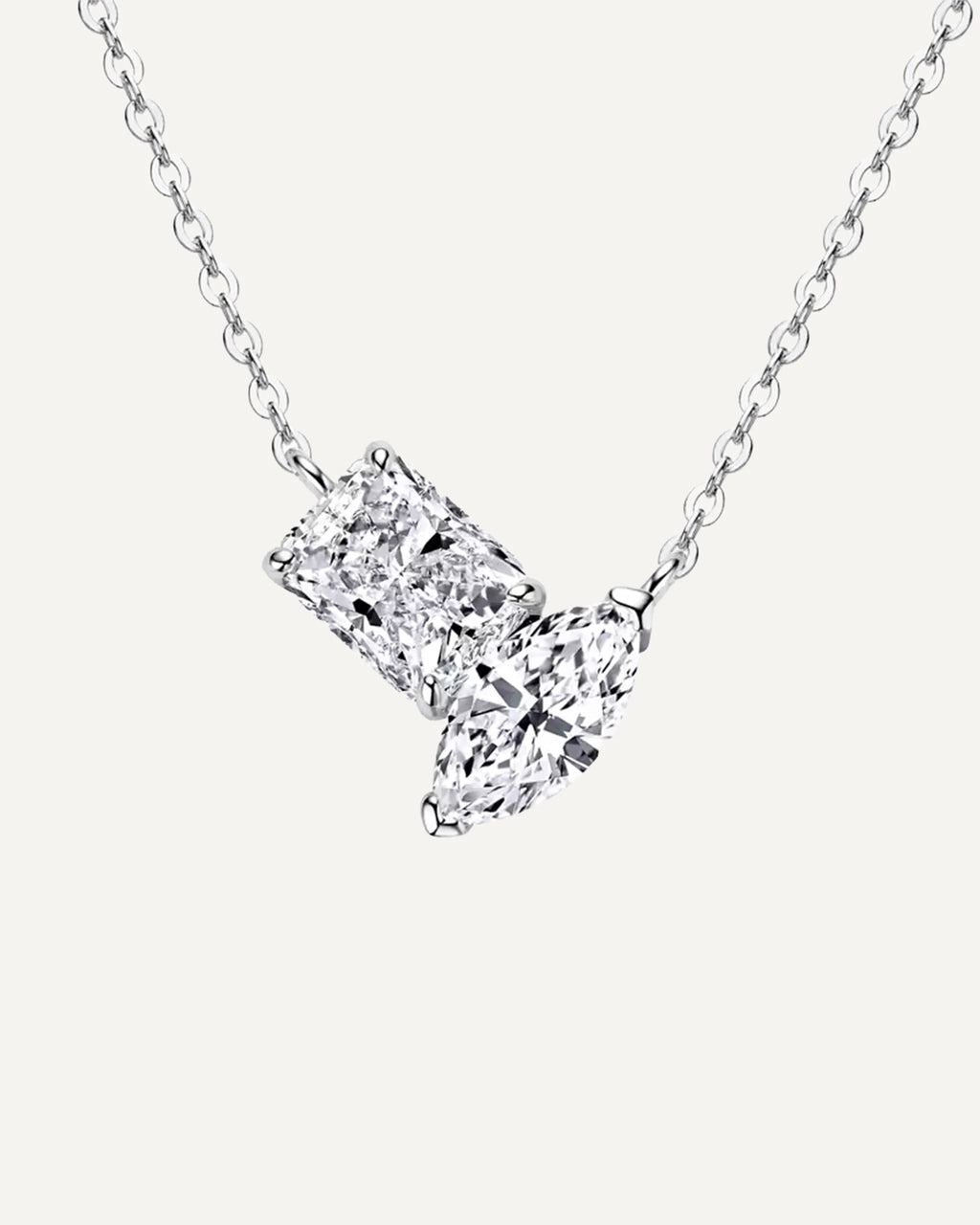 Front view of the silver-tone Elise necklace with rectangular and marquise stones in an asymmetric pendant.
