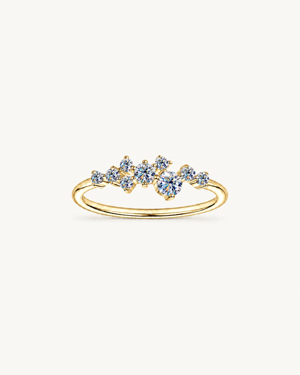 Gold Estelle ring with graduated round moissanite stones in an asymmetric scatter setting