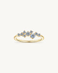 Gold Estelle ring with graduated round moissanite stones in an asymmetric scatter setting