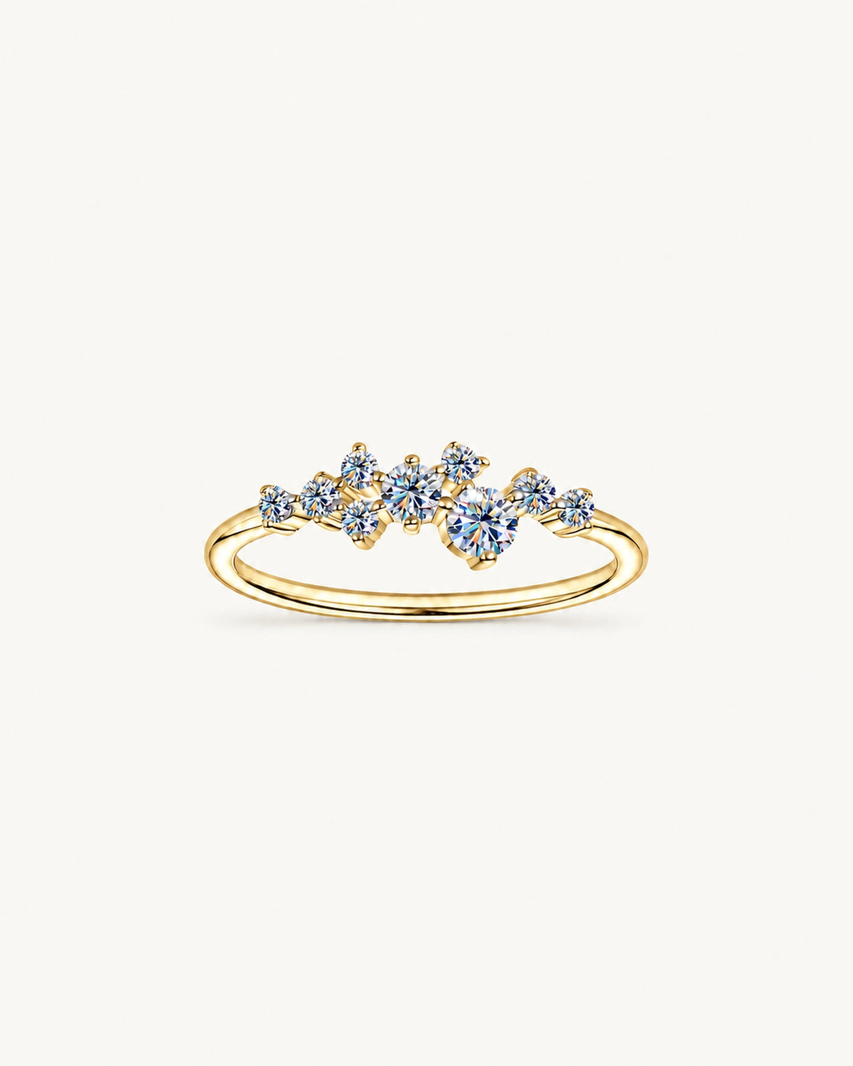 Gold Estelle ring with graduated round moissanite stones in an asymmetric scatter setting