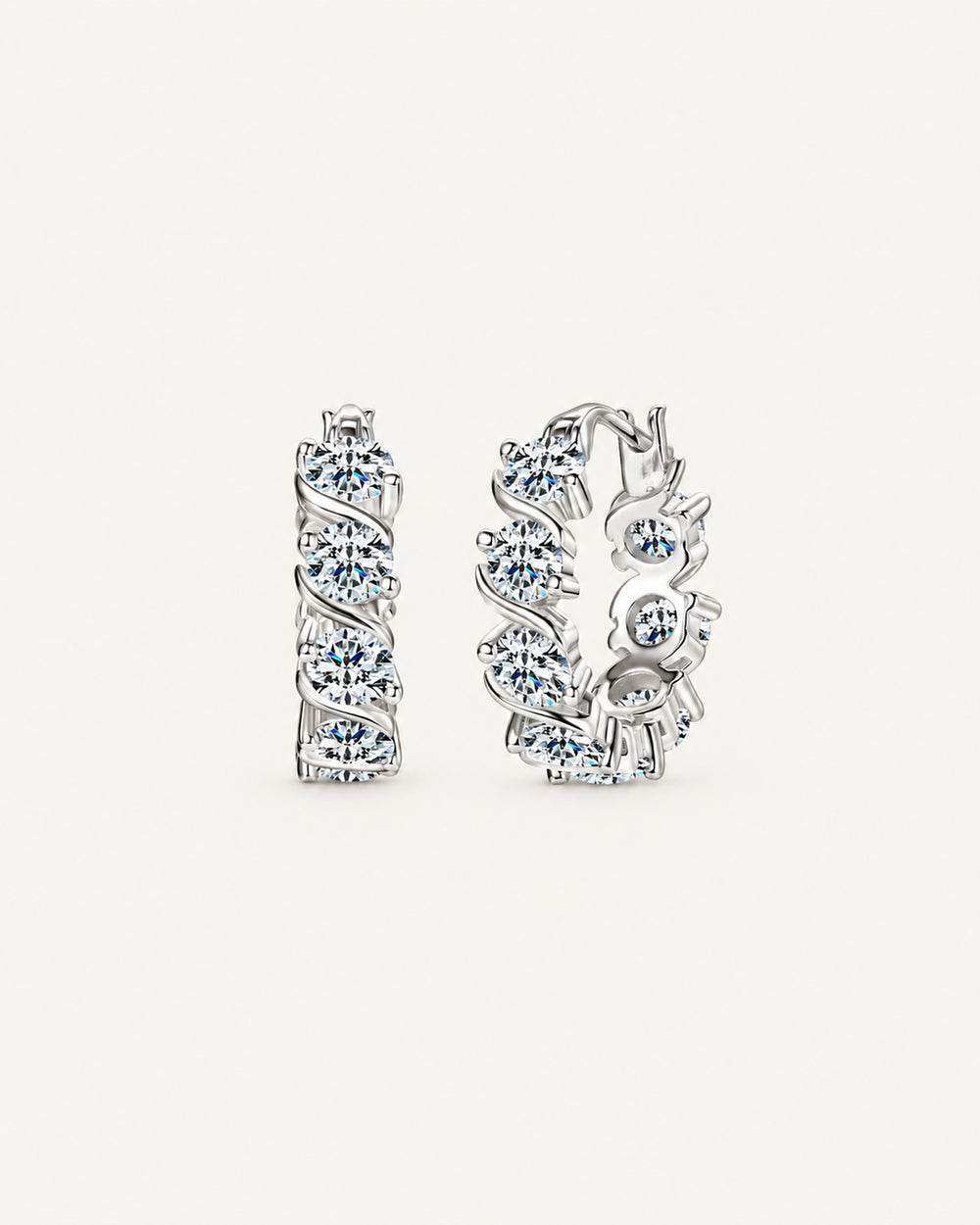 Silver Noelle hoop earrings with round moissanite stones framed by diagonal ribbon settings