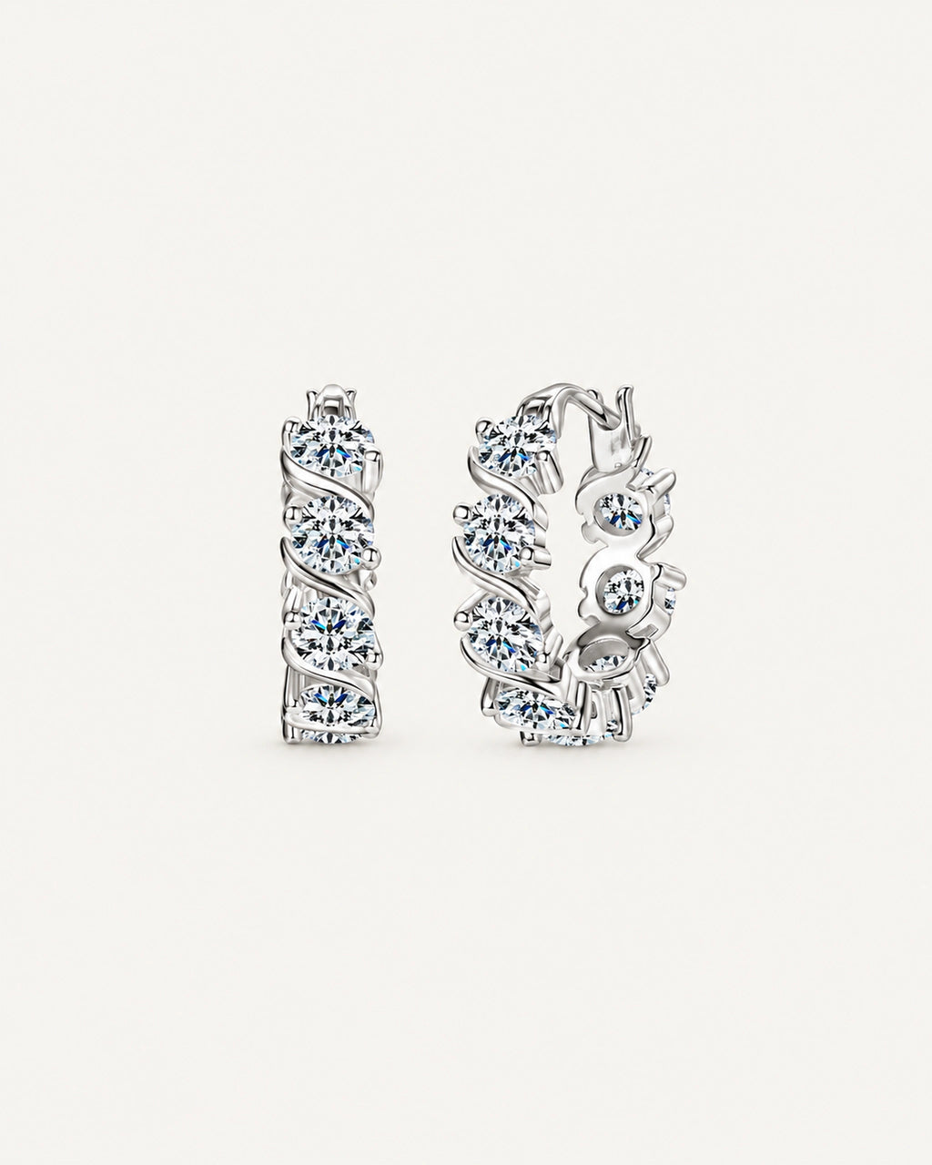 Silver Noelle hoop earrings with round moissanite stones framed by diagonal ribbon settings
