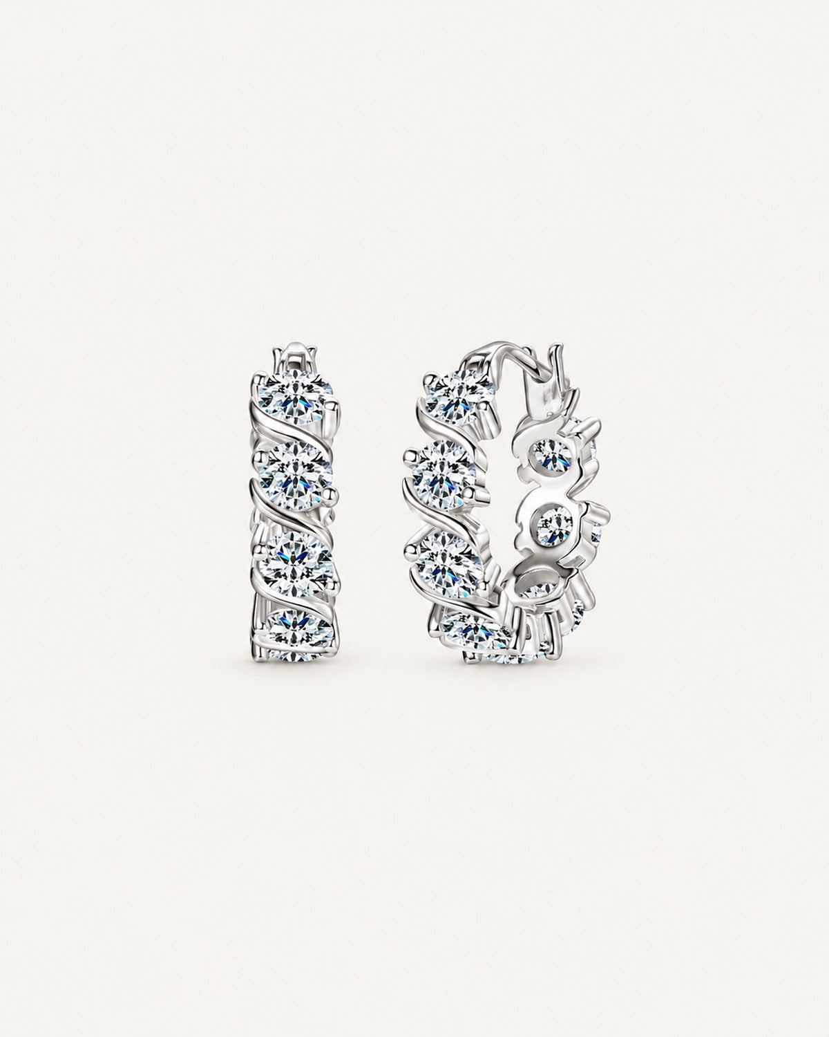 Silver Noelle hoop earrings with round moissanite stones framed by diagonal ribbon settings