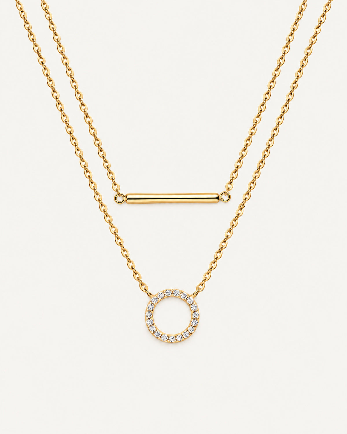 Gold Simone double-layer necklace with a plain horizontal bar above an open moissanite circle